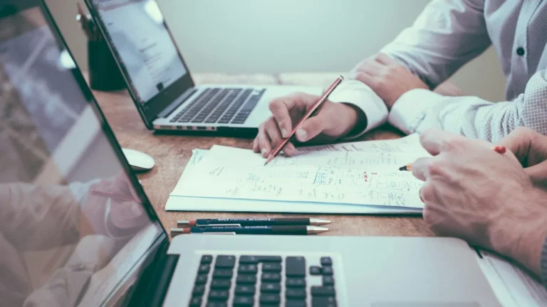 business plan drafting with laptop and notes